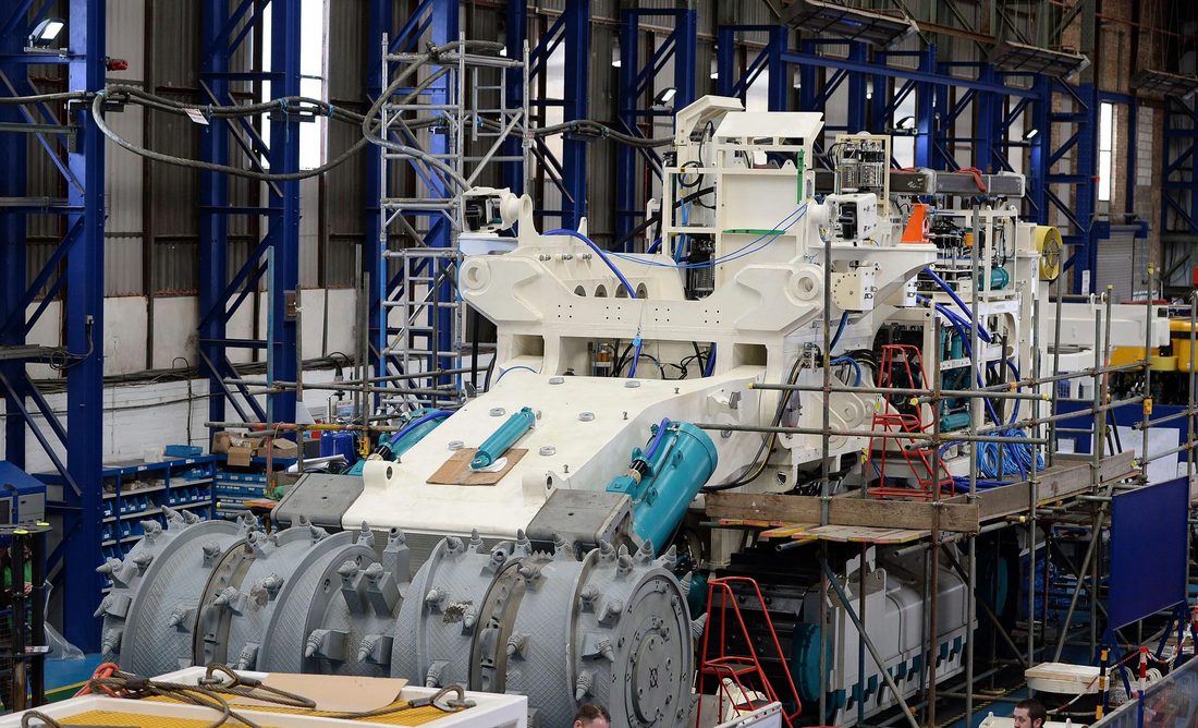 Heavy industrial machinery being assembled on a factory floor in China